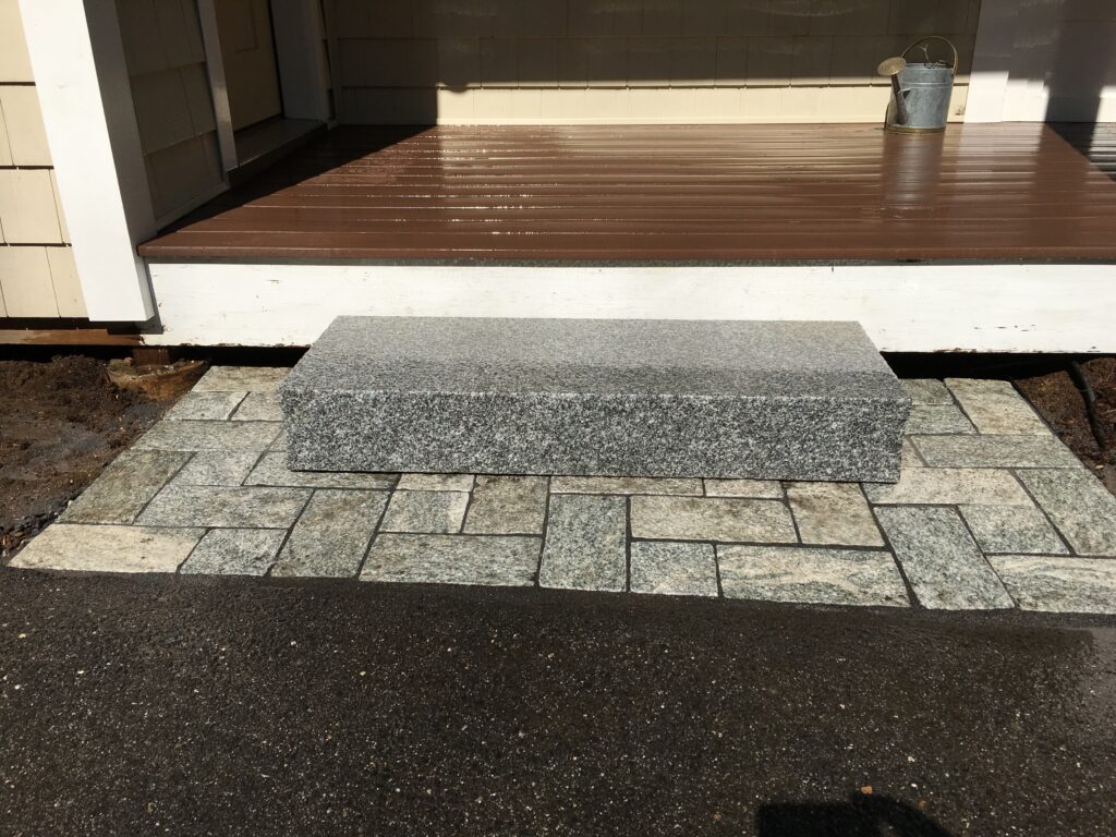 Granite step over granite pavers